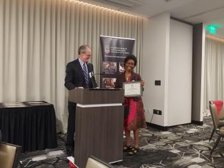 Dean Dorsey presents award to Dr. Maganda.