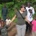 Student in Tanzania with children.